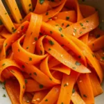 Carrot Ribbon Salad in a ceramic bowl with herbs and seeds